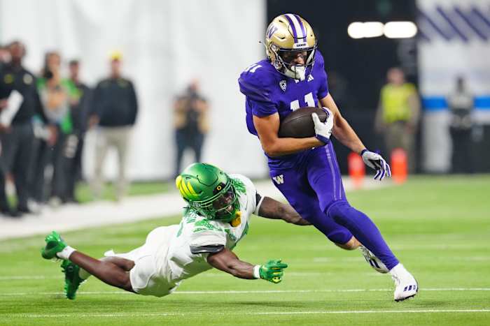Washington Huskies wide receiver Jalen McMillan evades a tackle from Oregon's Khyree Jackson in the Pac-12 Championship.